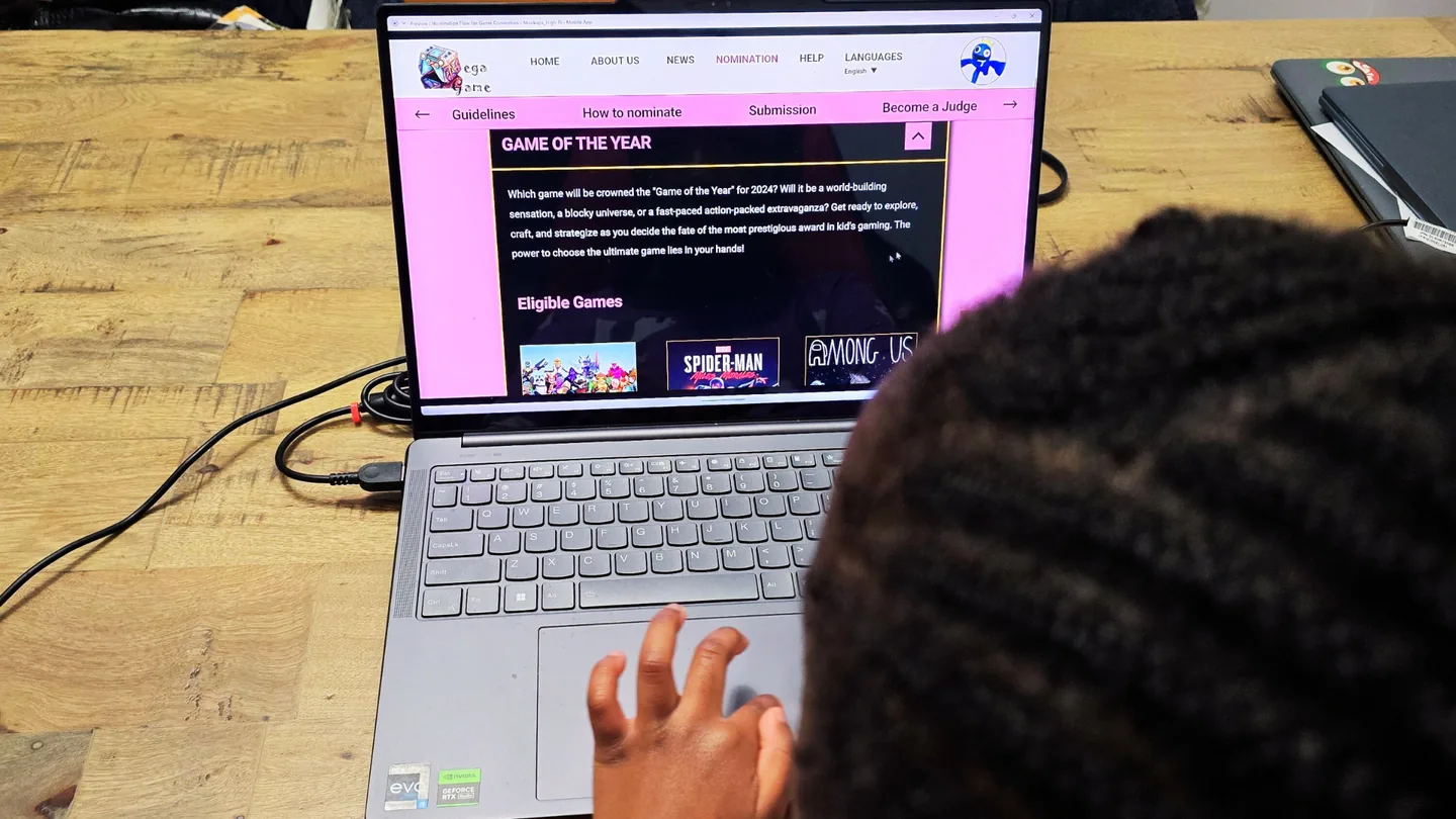 Child testing the Mega Game Award nomination experience on a laptop